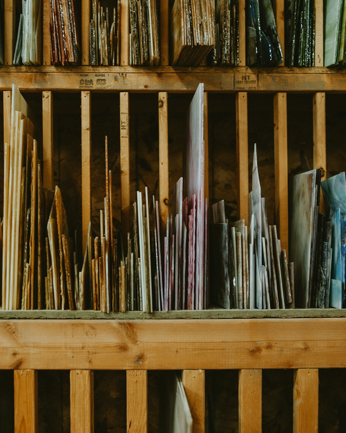 a wooden shelf filled with lots of different types of umbrellas