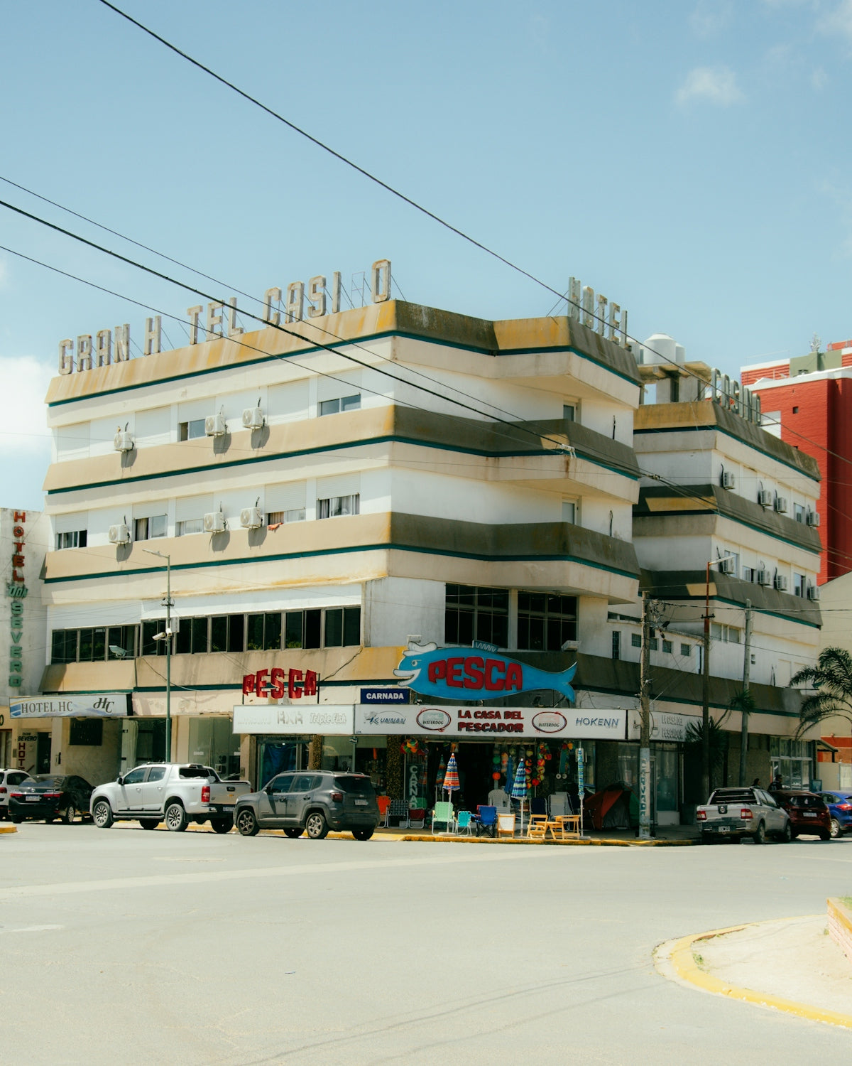 A street corner with cars parked in front of a building