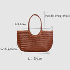 Carmel - Borsa a spalla in vera pelle a forma di U intrecciata a mano Nera